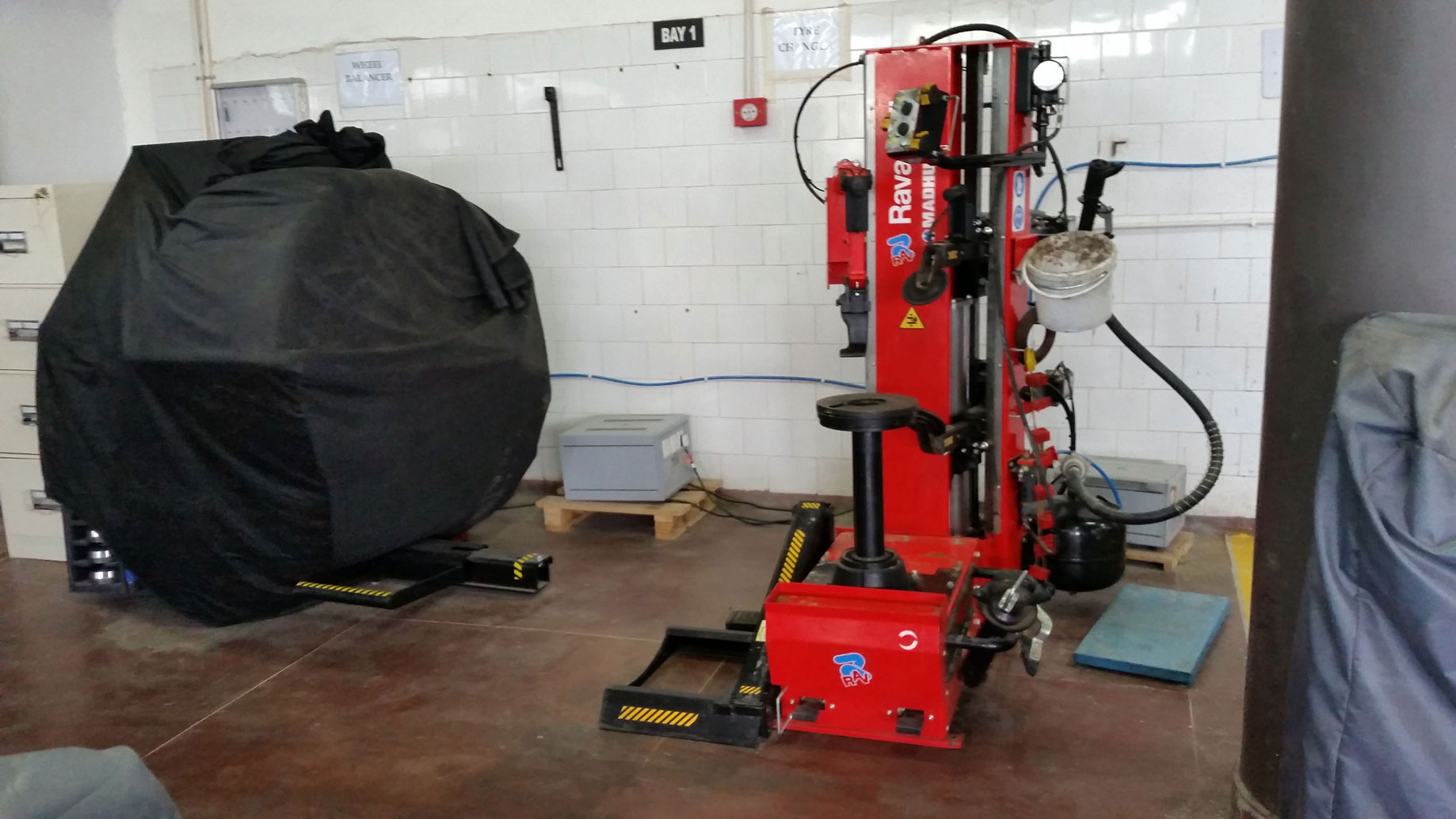 Red Ravaglioli tyre changer installed inside a workshop